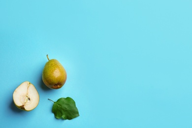 Ripe juicy pears on blue background, flat lay. Space for text