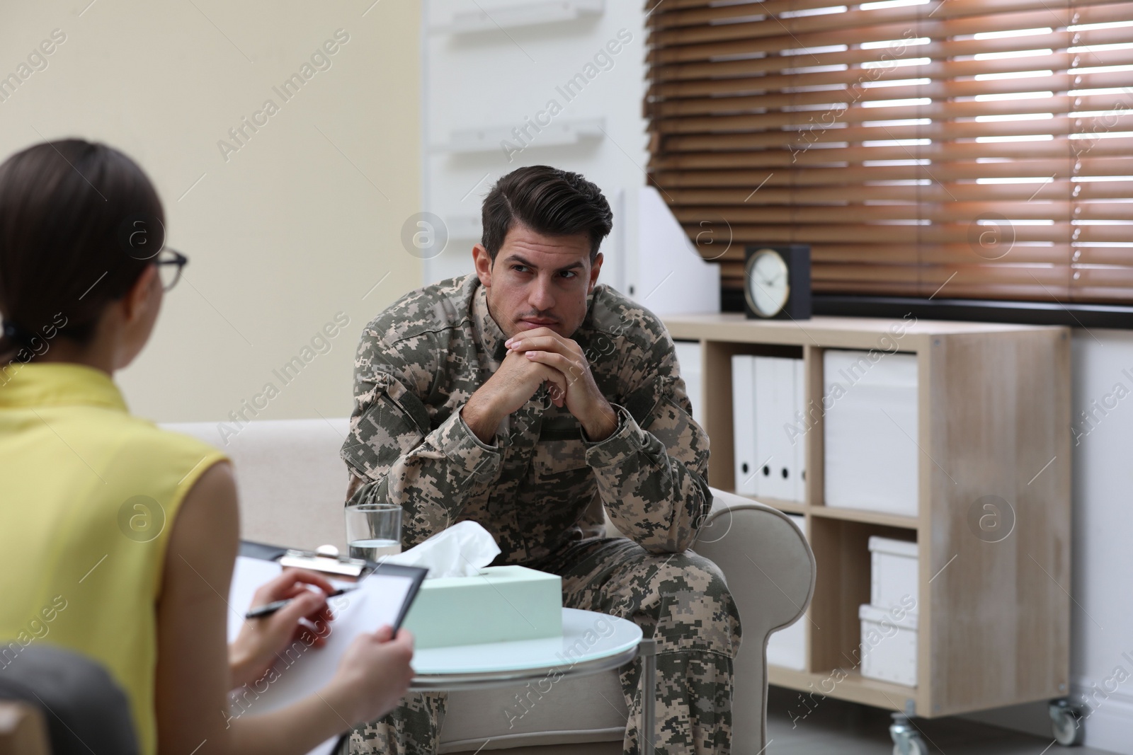 Photo of Psychotherapist working with male military officer in office