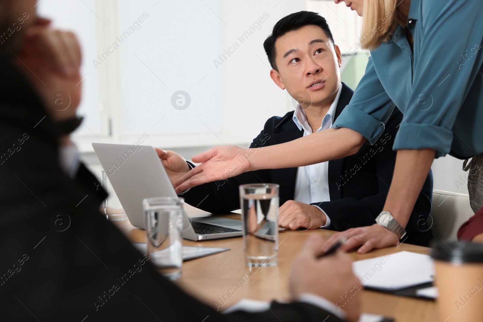 Photo of Businesswoman having meeting with her employees in office, closeup