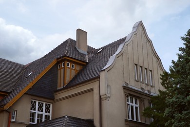 Beautiful house with black roof against blue sky