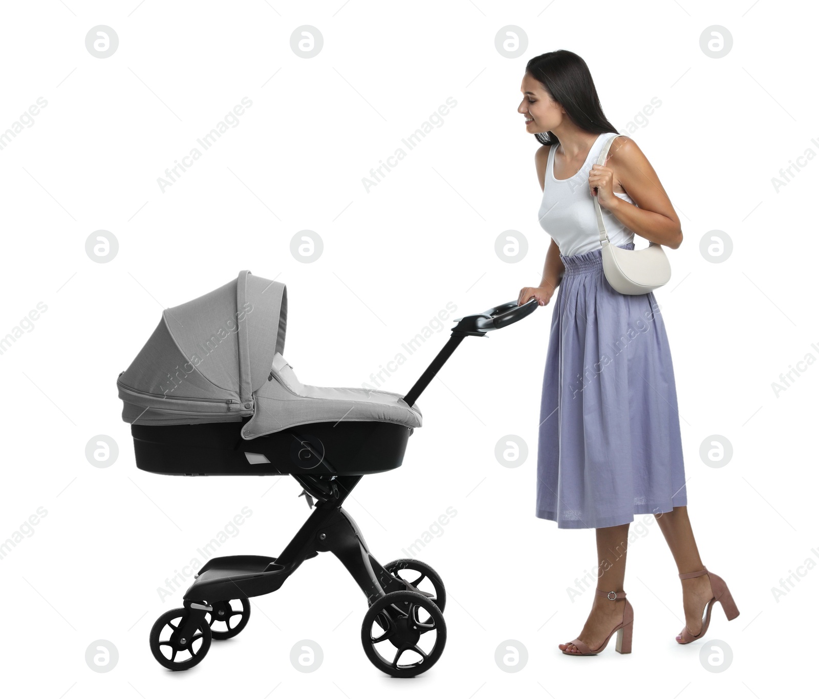 Photo of Happy young woman with baby stroller on white background