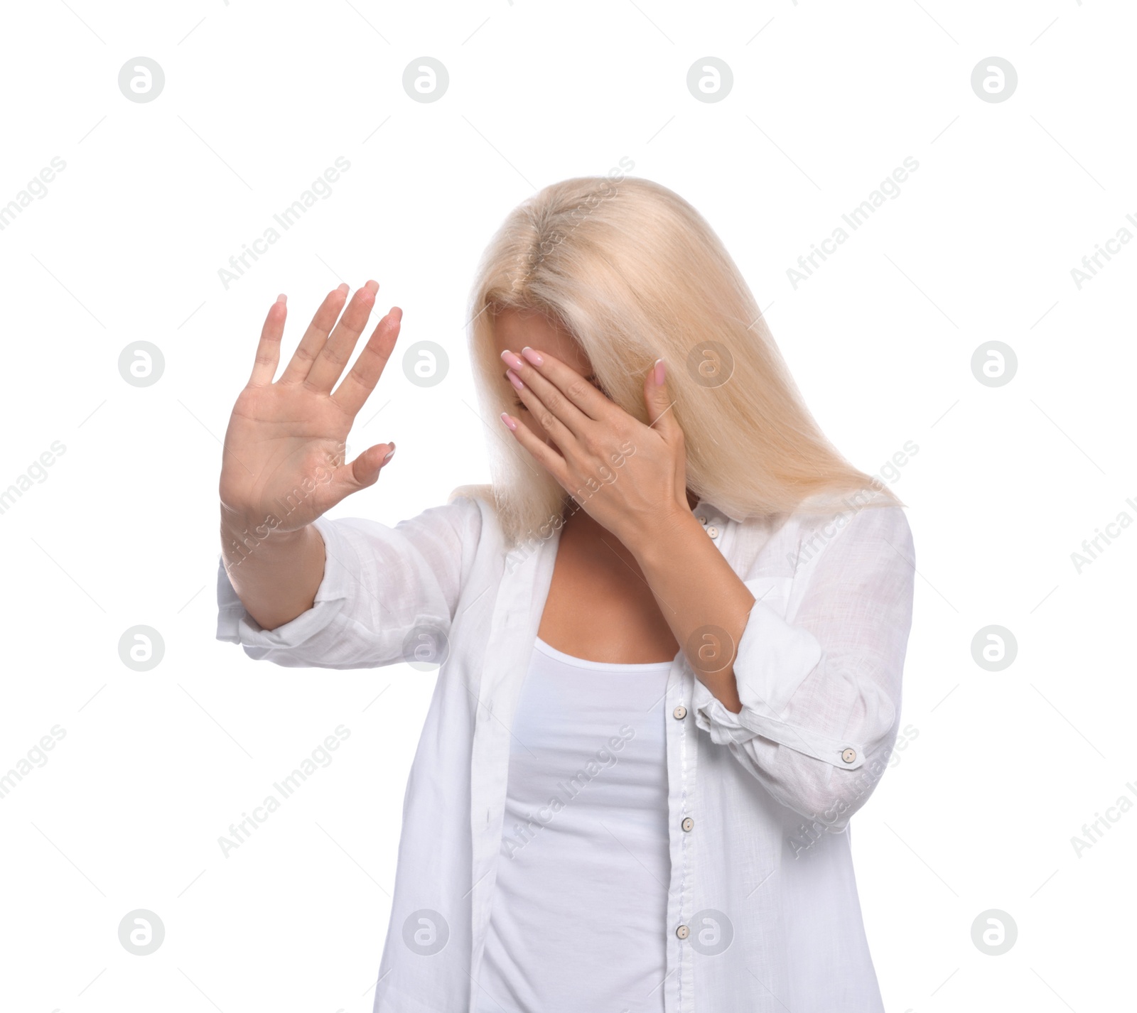 Photo of Embarrassed woman covering face with hand on white background