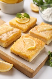 Photo of Tasty lemon bars on white table, closeup