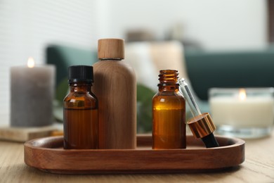 Aromatherapy. Bottles of essential oil on wooden table