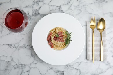 Photo of Delicious Carbonara pasta served on white marble table, flat lay