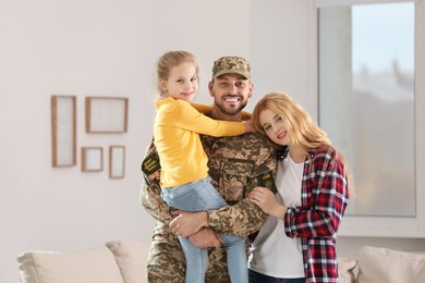 Photo of Soldier in Ukrainian military uniform reunited with his family at home