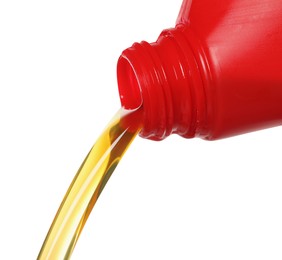 Pouring motor oil from red container isolated on white