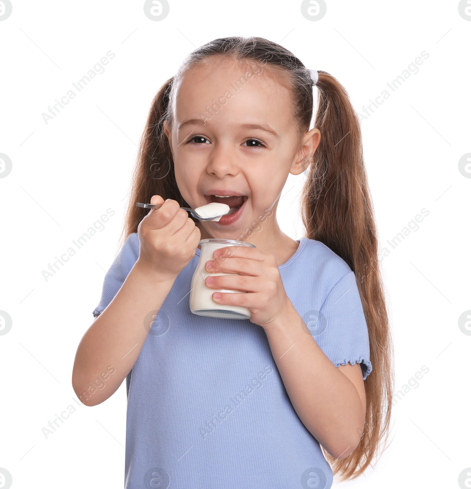 Photo of Cute little girl eating tasty yogurt on white background