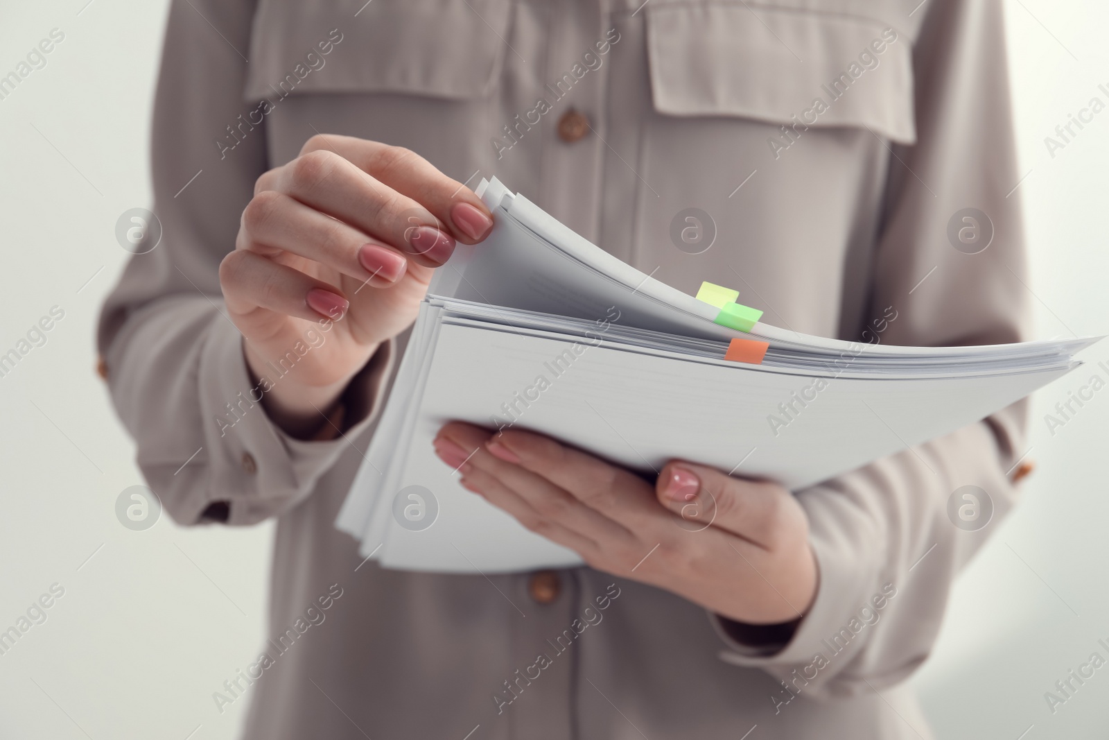 Photo of Woman stacking documents on white background, closeup