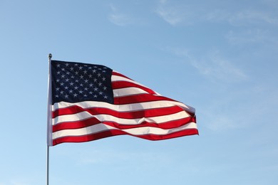 Photo of American flag fluttering outdoors on sunny day