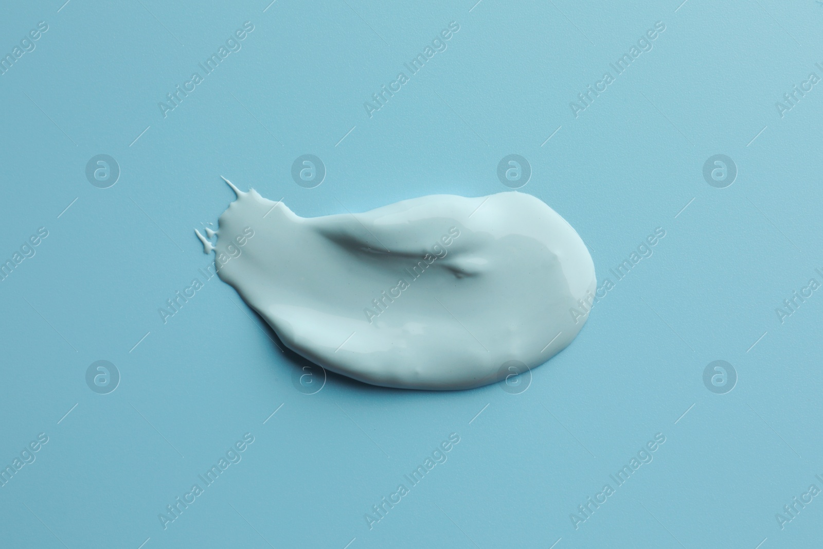 Photo of Sample of face mask on light blue background, top view