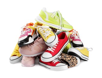 Pile of different female sneakers isolated on white