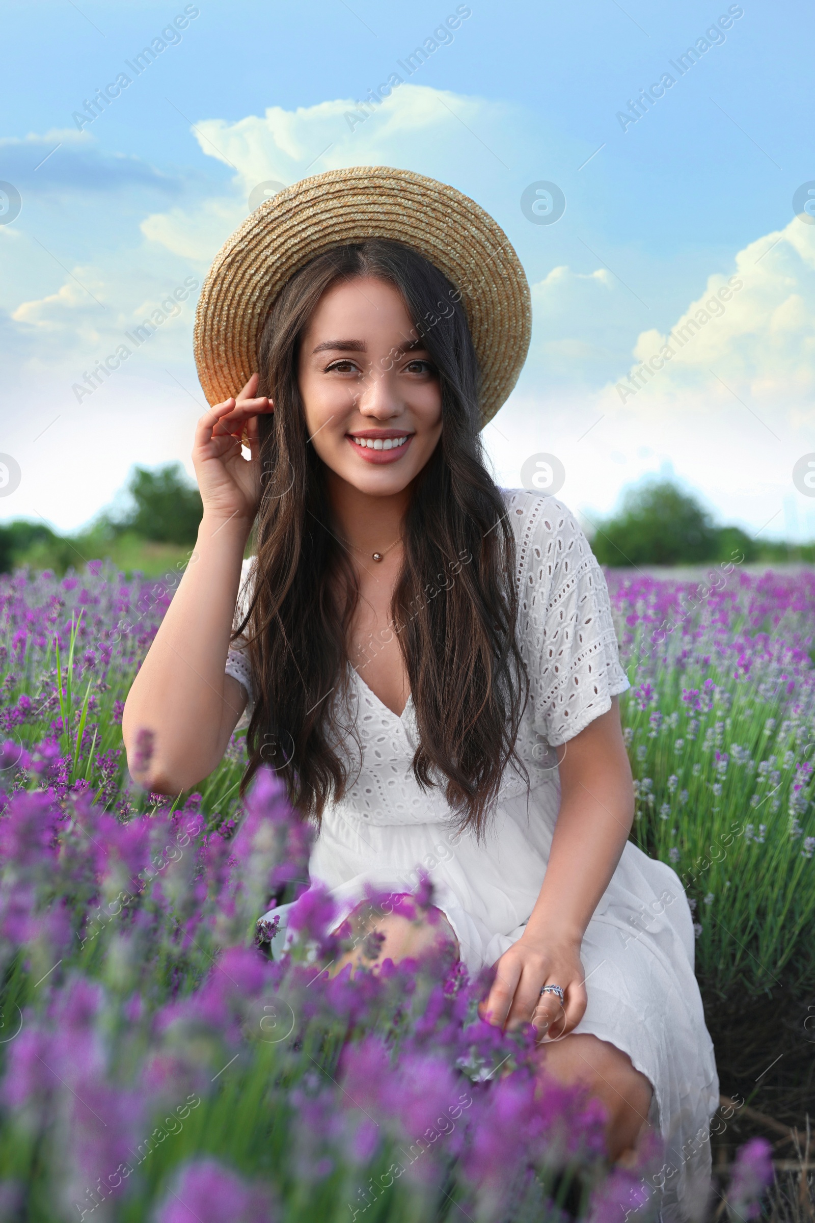 Photo of Young woman in lavender field on summer day