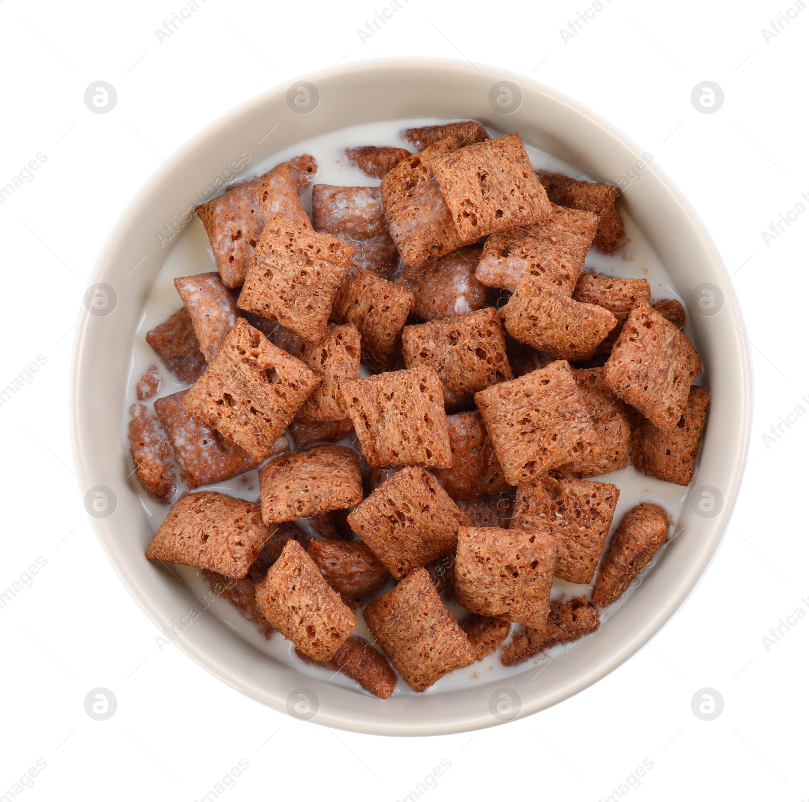 Photo of Tasty corn pads with milk in bowl isolated on white, top view