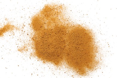 Photo of Pile of brown dust scattered on white background