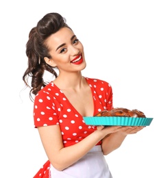 Funny young housewife with homemade pastry on white background