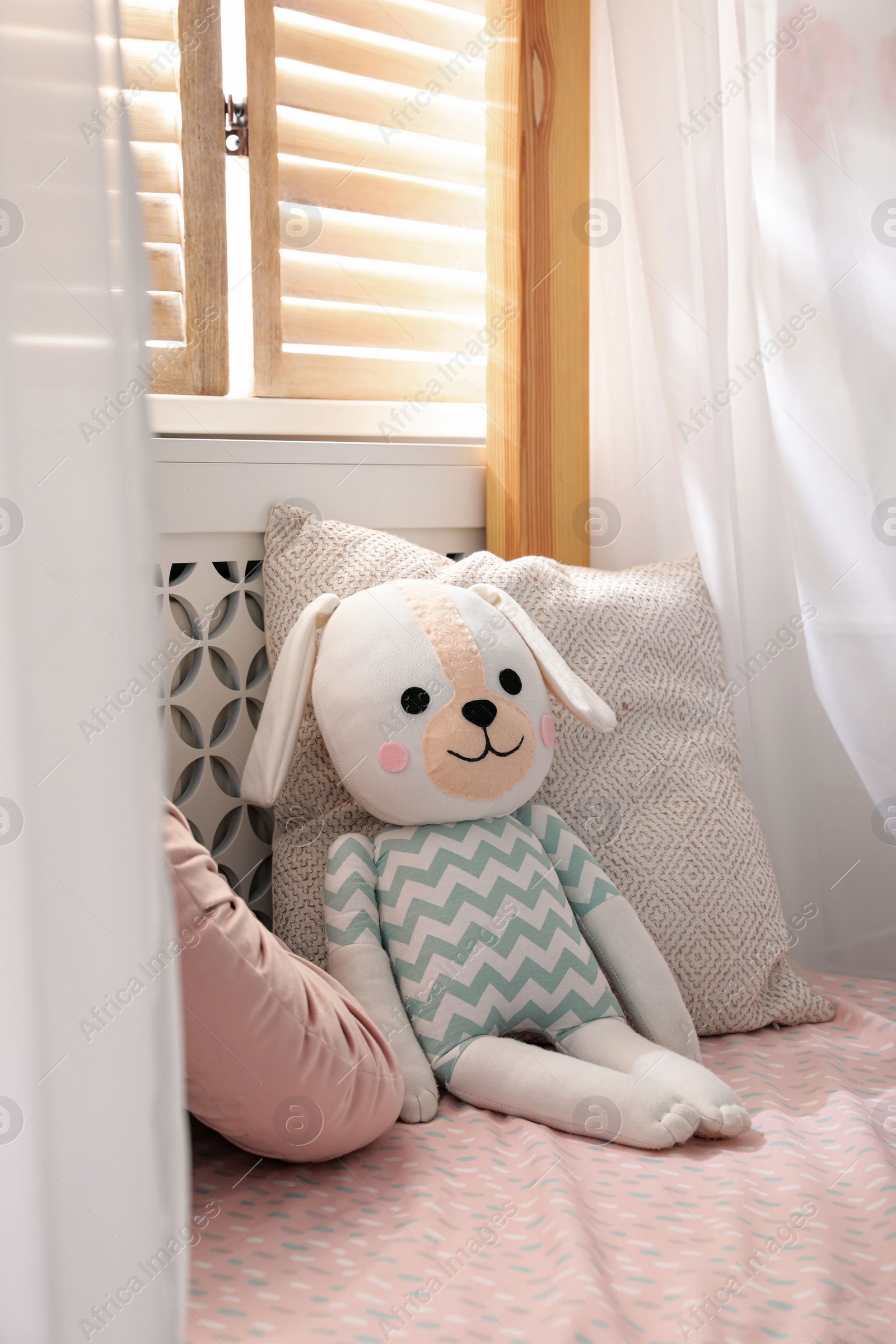 Photo of Toy dog on bed in child's room