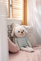 Photo of Toy dog on bed in child's room