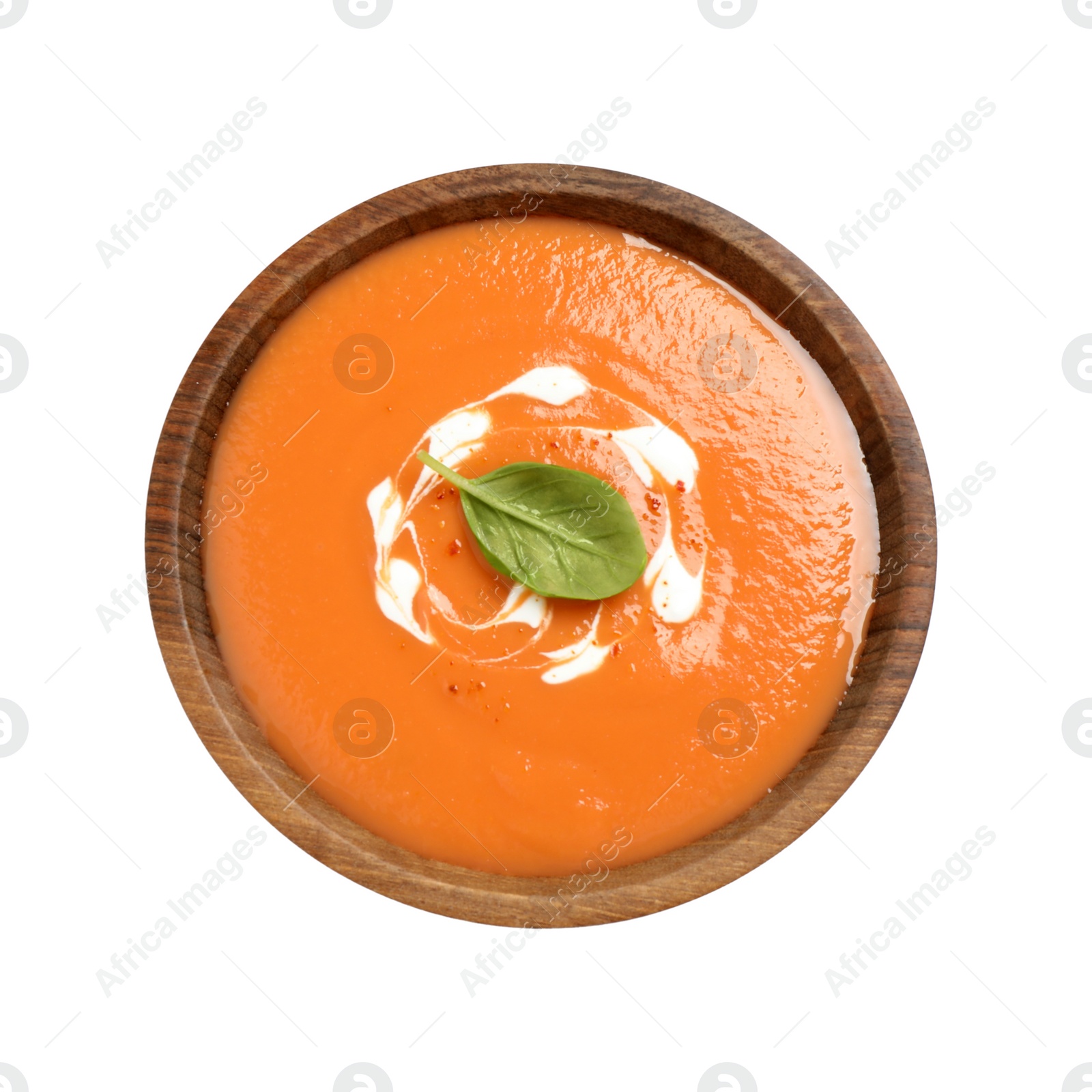 Photo of Tasty creamy pumpkin soup with basil in bowl on white background, top view