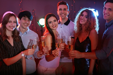 Young people celebrating birthday in nightclub