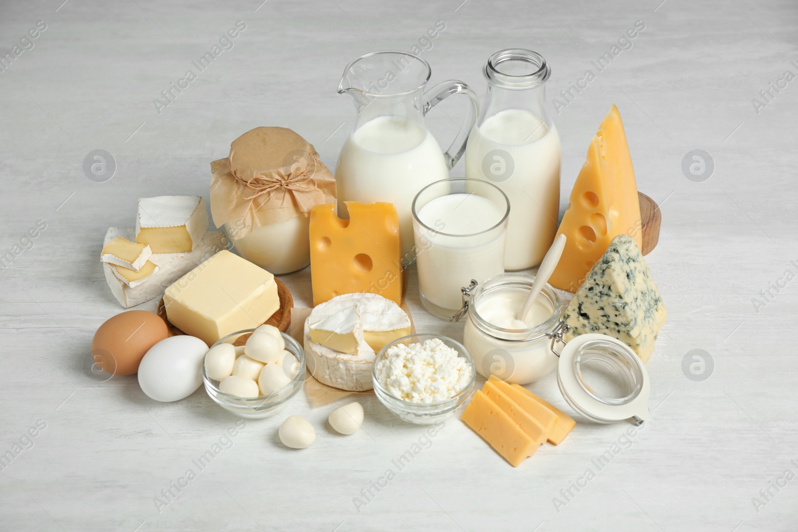 Photo of Different delicious dairy products on white table