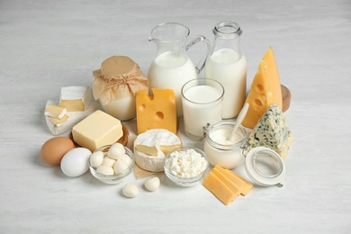 Photo of Different delicious dairy products on white table
