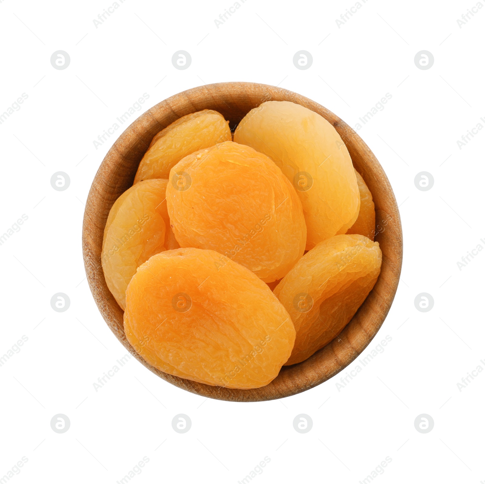 Photo of Wooden bowl with dried tasty apricots isolated on white, top view