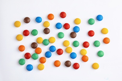 Photo of Tasty colorful candies on white background, top view