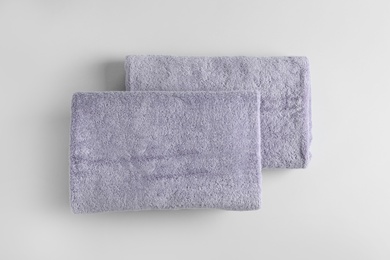 Fresh fluffy towels on grey background, top view. Mockup for design