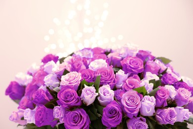 Image of Bouquet of violet roses against blurred background, closeup. Funeral attributes