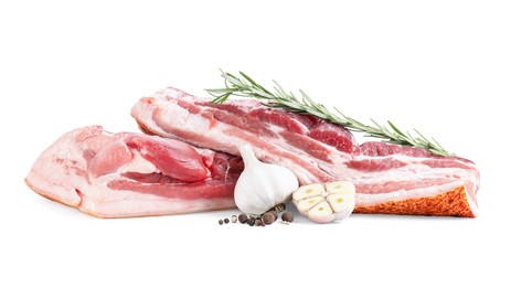 Photo of Pieces of raw pork belly, garlic, rosemary and peppercorns isolated on white