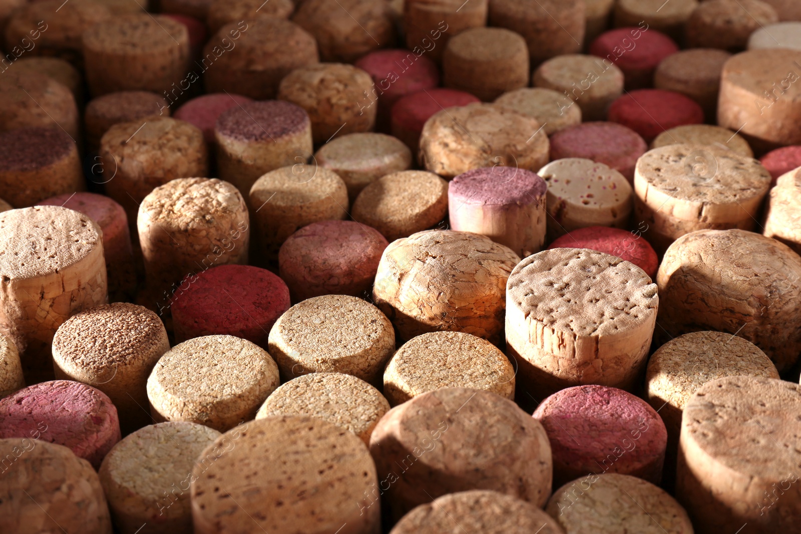 Photo of Many corks of wine bottles as background, closeup