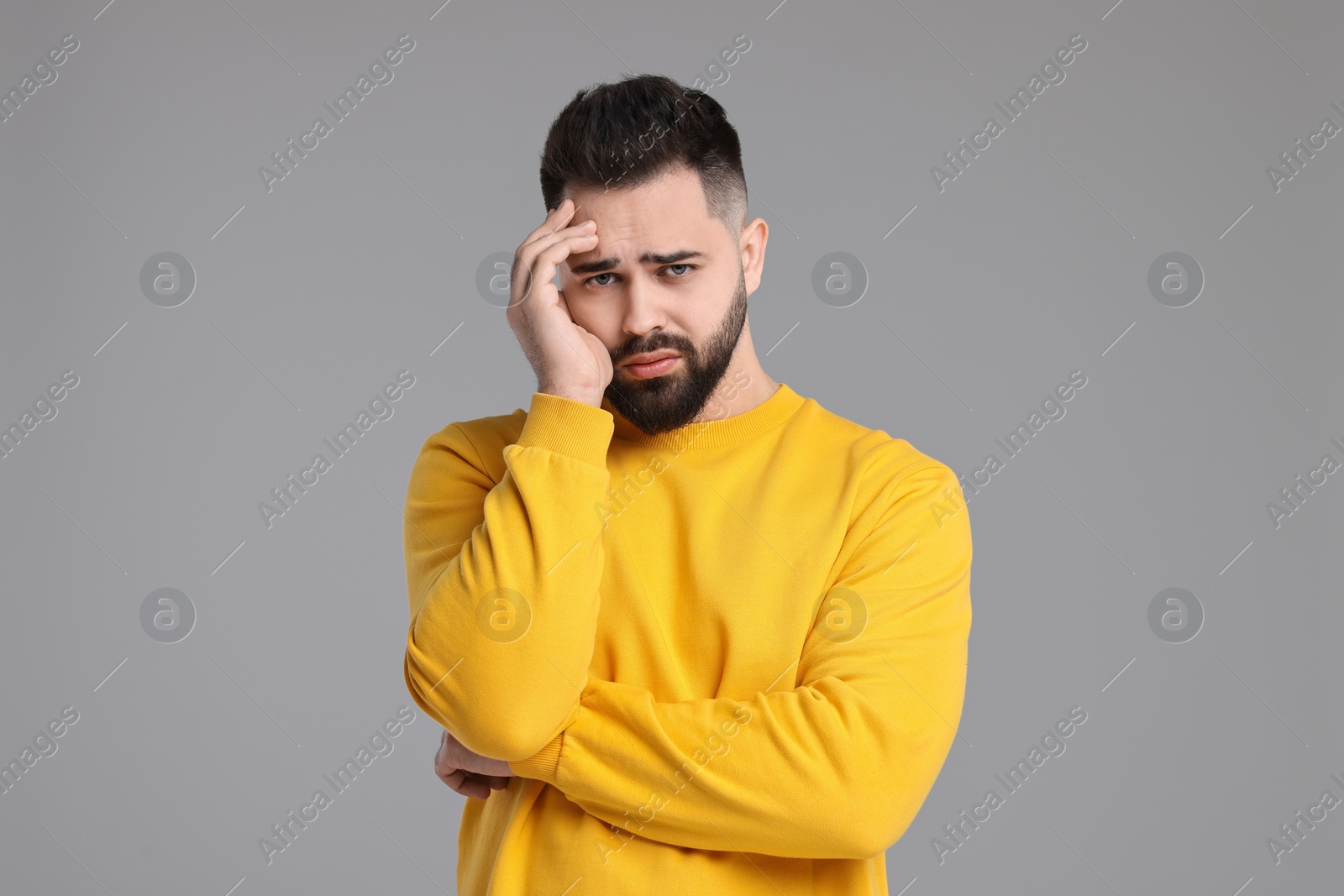 Photo of Portrait of sad man on light grey background