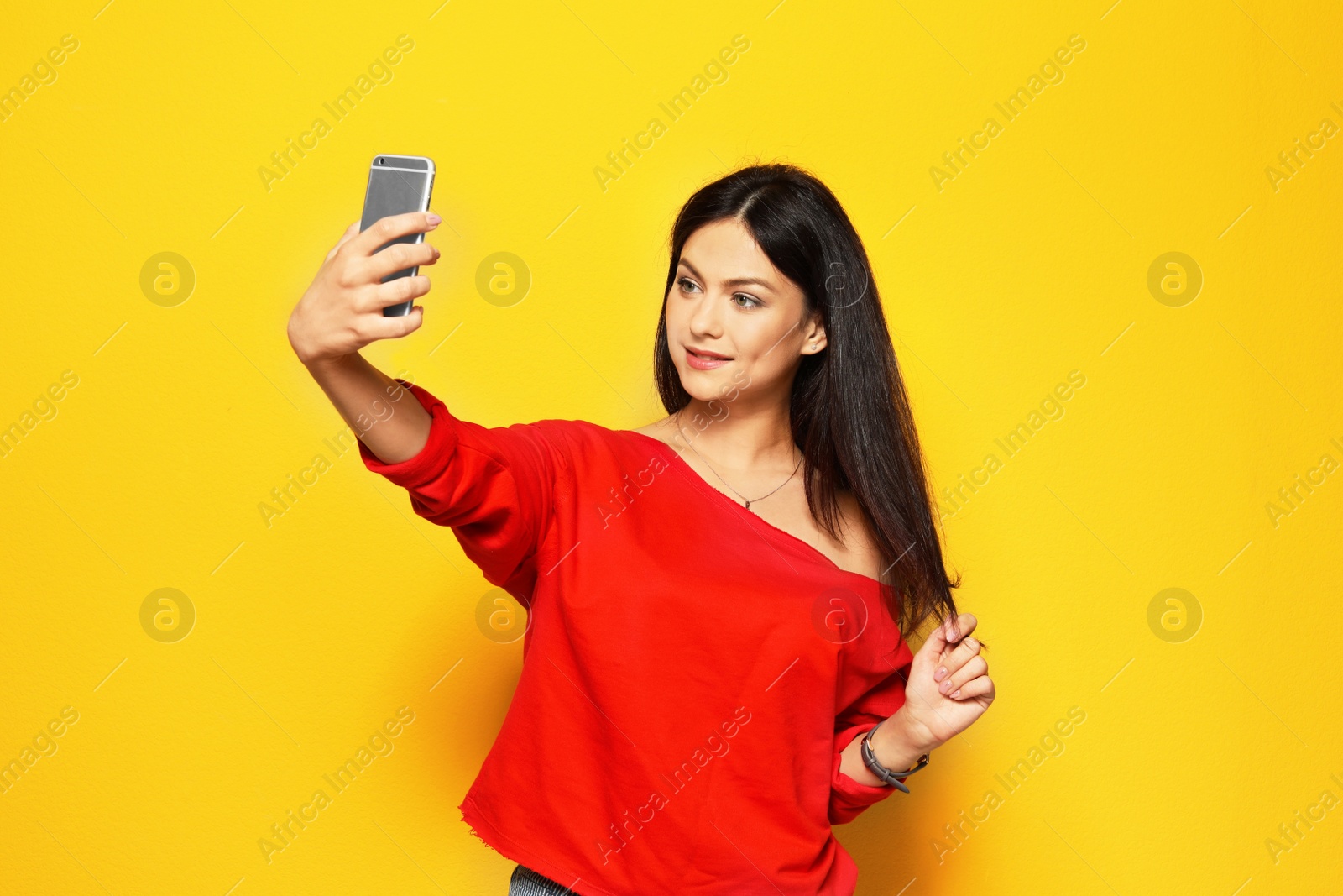 Photo of Attractive young woman taking selfie on color background