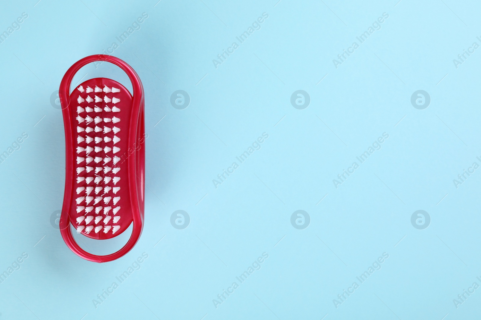 Photo of Pedicure foot brush on light blue background, top view. Space for text