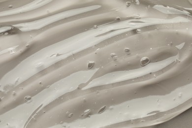 Photo of Clear cosmetic gel on grey background, closeup