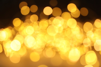 Photo of Gold glitter with bokeh effect on dark background