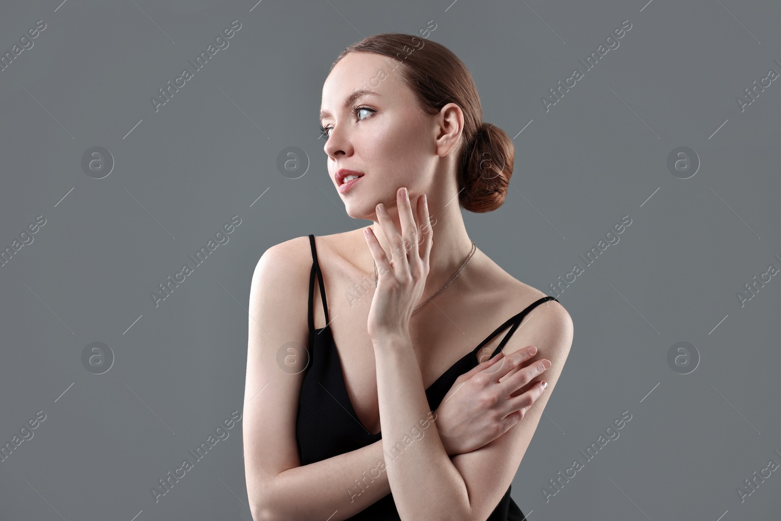 Photo of Fashionable portrait of beautiful young woman on grey background