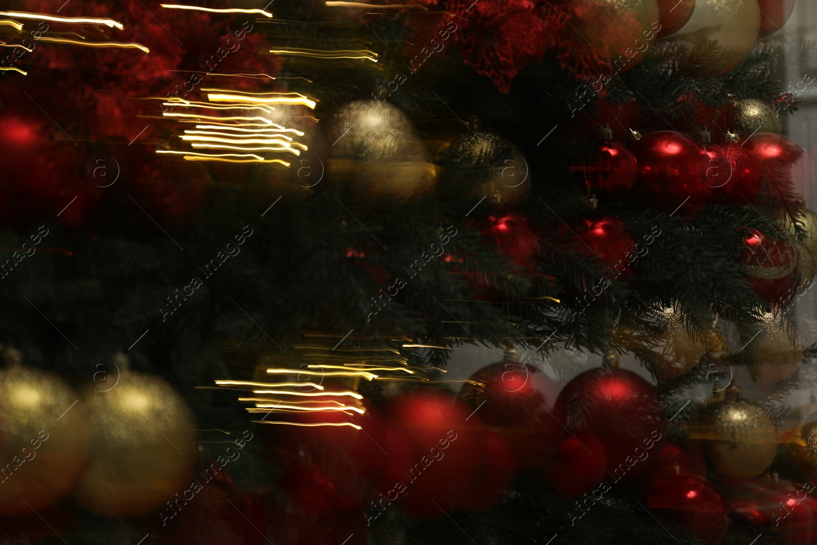 Photo of Decorated Christmas tree with red and golden ornaments, motion blur