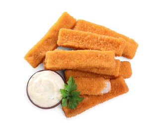 Fresh breaded fish fingers with parsley and sauce on white background, top view