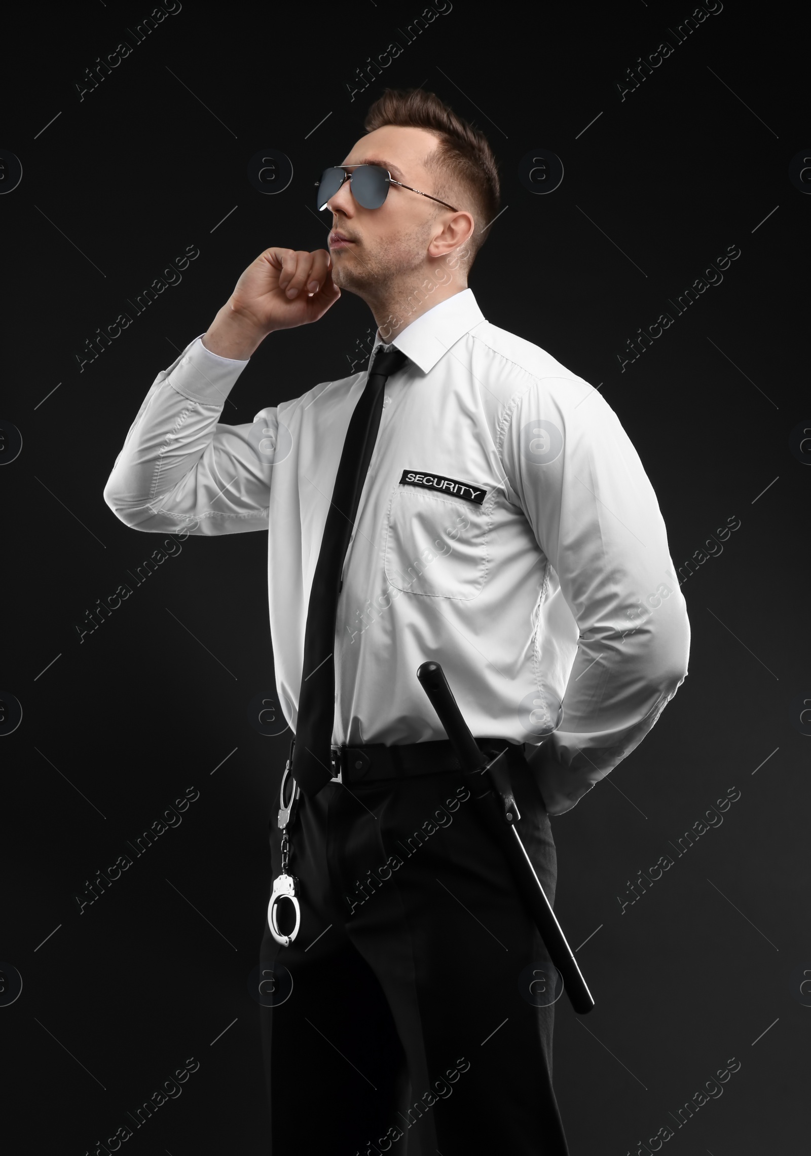 Photo of Male security guard in uniform on dark background