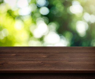 Image of Empty wooden surface against blurred green background. Space for design