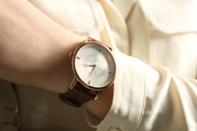 Woman wearing luxury wristwatch, closeup of hand