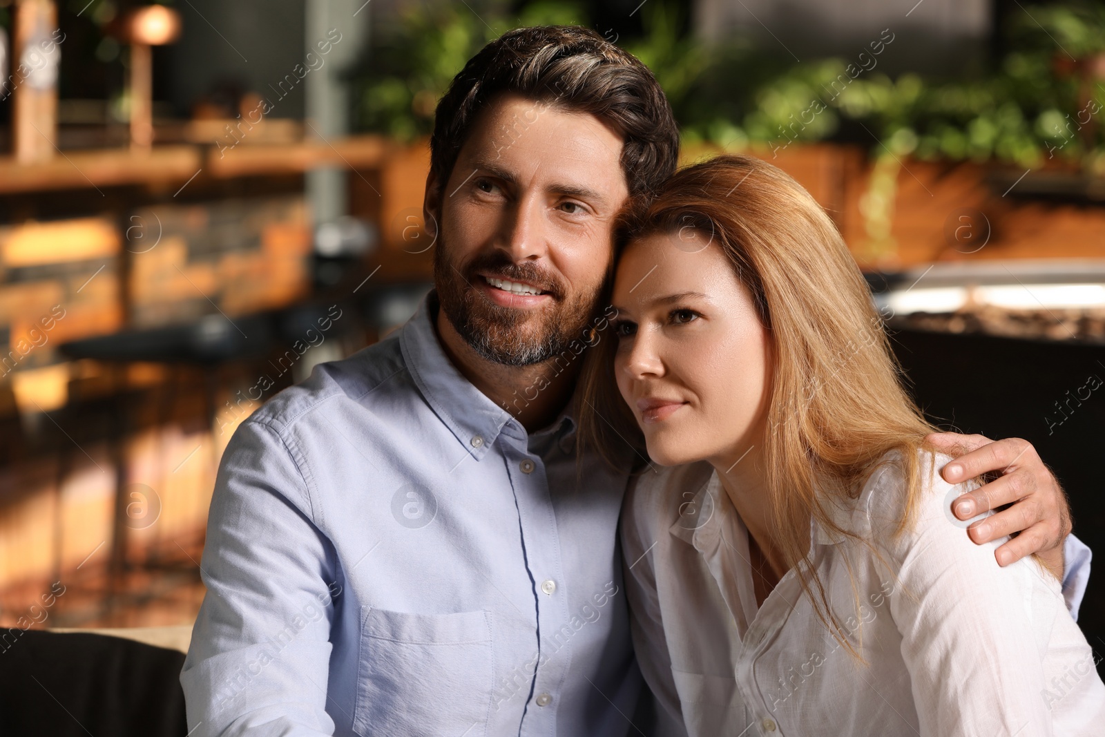 Photo of Romantic date. Lovely couple spending time together in cafe