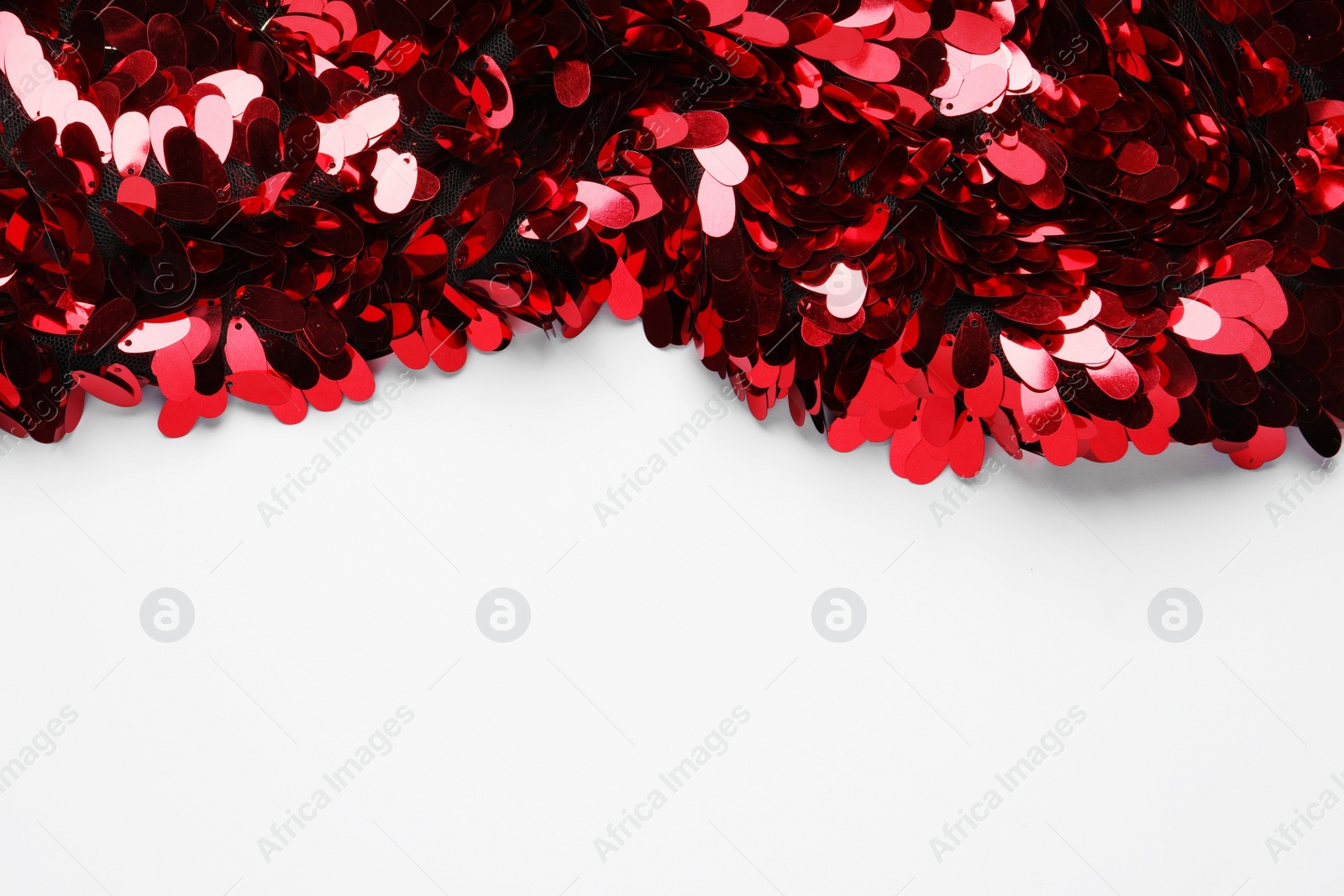 Photo of Beautiful red sequin fabric on white background. Space for text