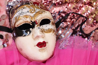 Photo of Carnival mask and beautiful pink costume with sequins, above view