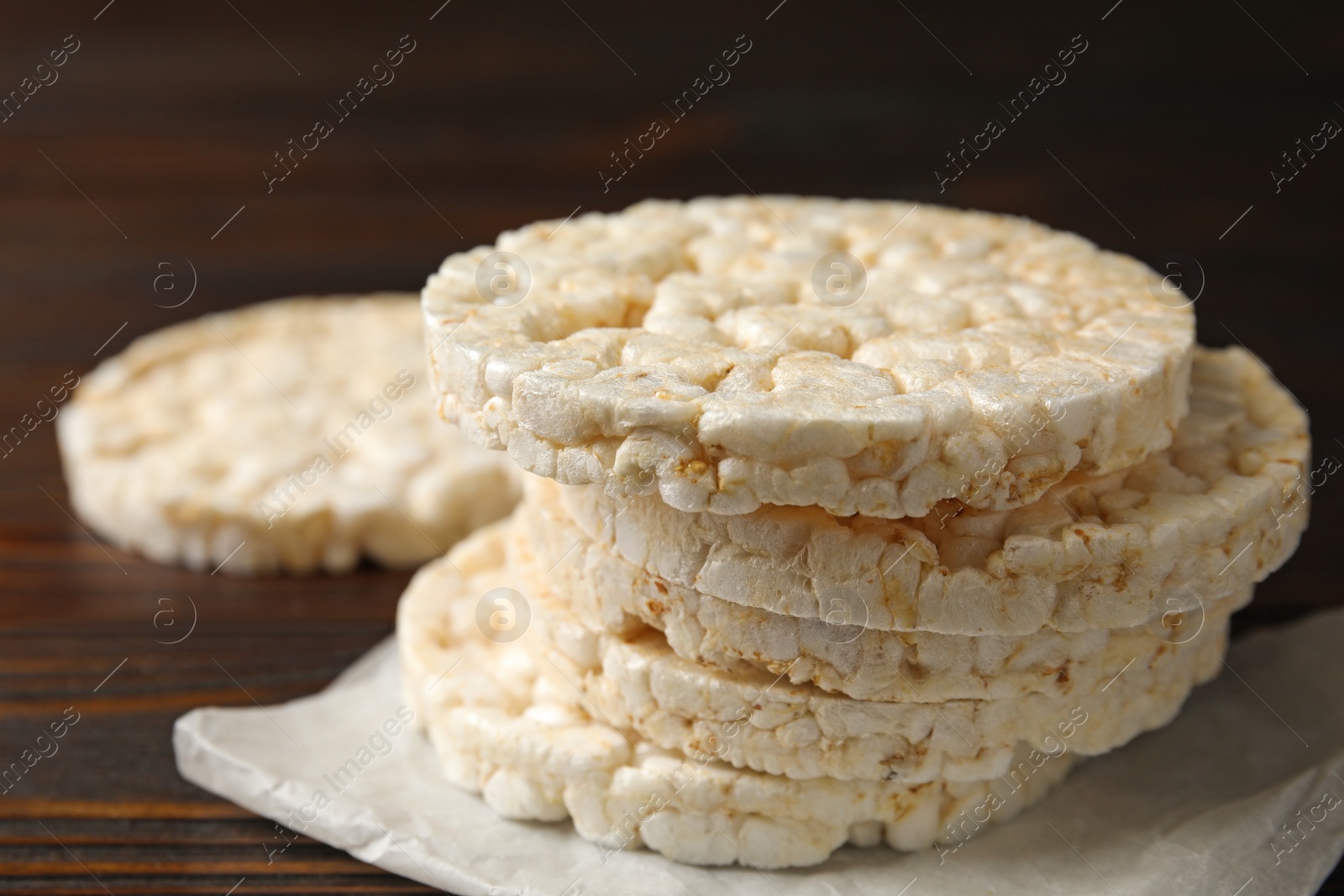 Photo of Stack of crunchy rice cakes on wooden table, closeup