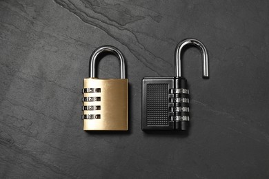 Photo of Steel combination padlocks on black table, top view