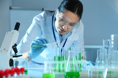 Female scientist working with sample in modern chemistry laboratory