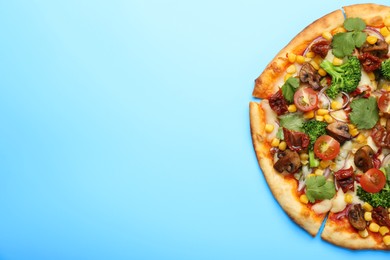 Photo of Delicious vegetarian pizza with mushrooms, vegetables and parsley on light blue background, top view. Space for text